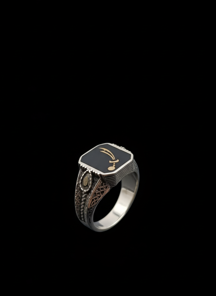 Silver ring with intricate design on a black background