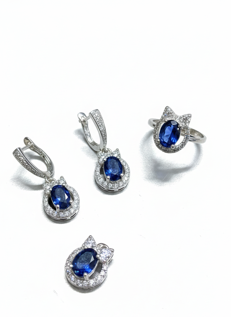 Jewelry set with sapphire earrings and ring on a white background